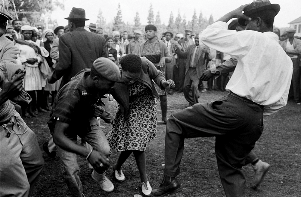 Ernest Cole, Revellers at a music festival, Gauteng [Transvaal], South Africa, c 1965. Estate Edition printed 2021. Hand-printed, Silver Gelatin prints on Ilford Fibre-based paper. Titled and numbered; signed on the reverse in pencil by Dennis da Silva and Leslie Matlaisane; embossed with Estate stamp. Image size: 37 x 55.5cm; sheet size: 51 x 61cm. Courtesy of The Melrose Gallery.