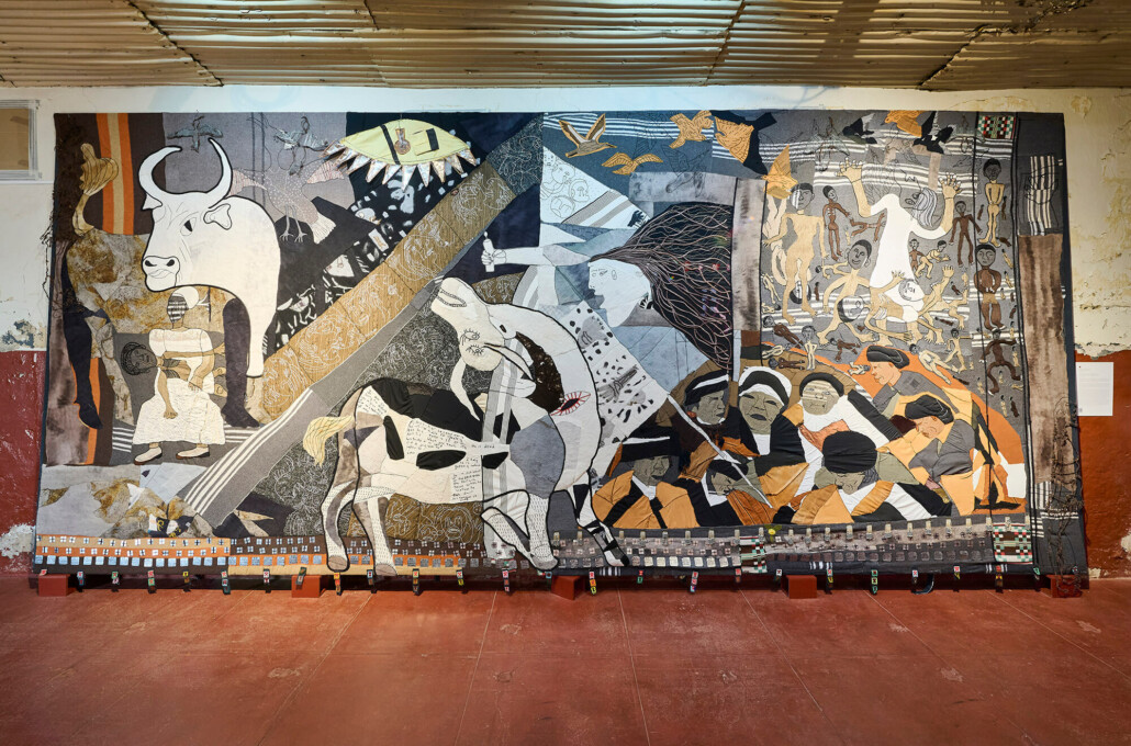 Keiskamma Guernica, 2010. Mixed media incl appliqué, felt, embroidery, rusted wire, metal tags,  beaded Aids ribbons, used blankets and old clothes, 3.5 x 7.8m. Courtesy of Anthea Pokroy/Keiskamma Trust